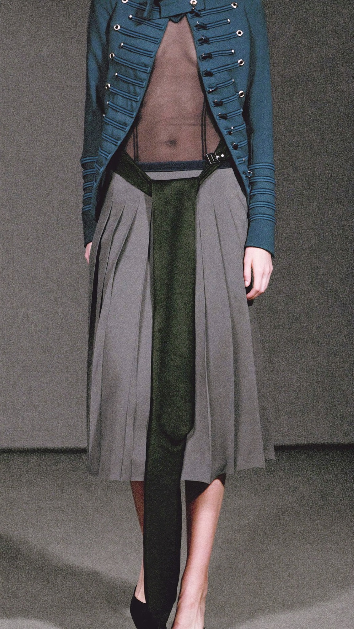 Full-length look with ridiculously long tie over mesh and military jacket