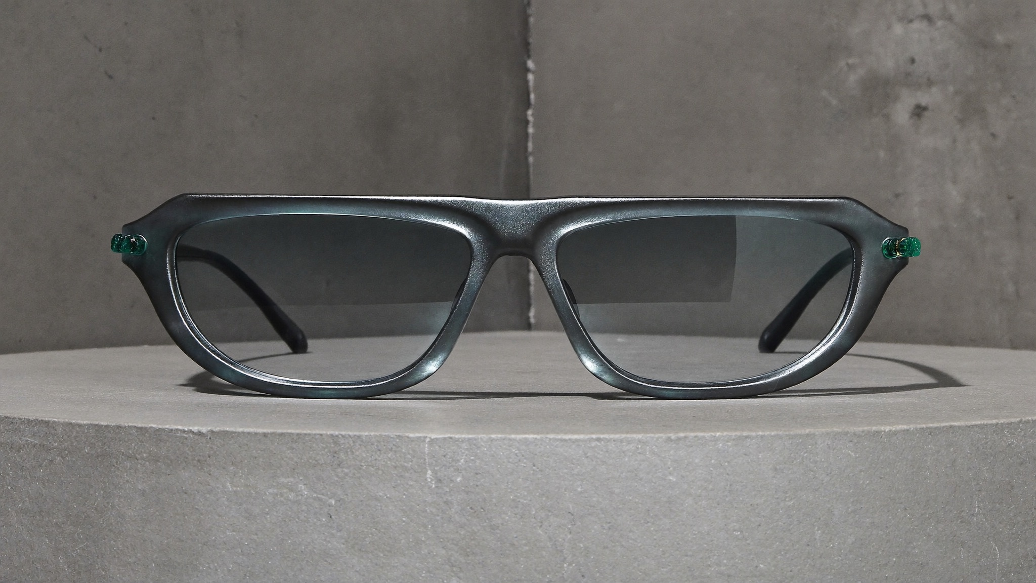 Glossy gunmetal composite sunglasses with teal pins